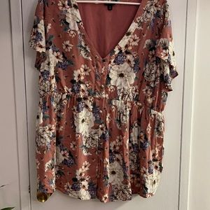 Pink top with white and green floral detailing